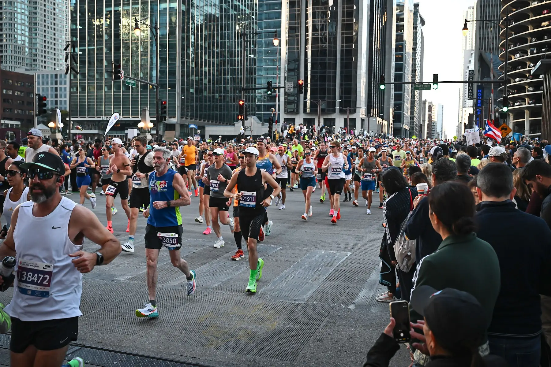 Runners crossing the river in the Loop during the early miles of the Chicago Marathon, with crowds lining the street