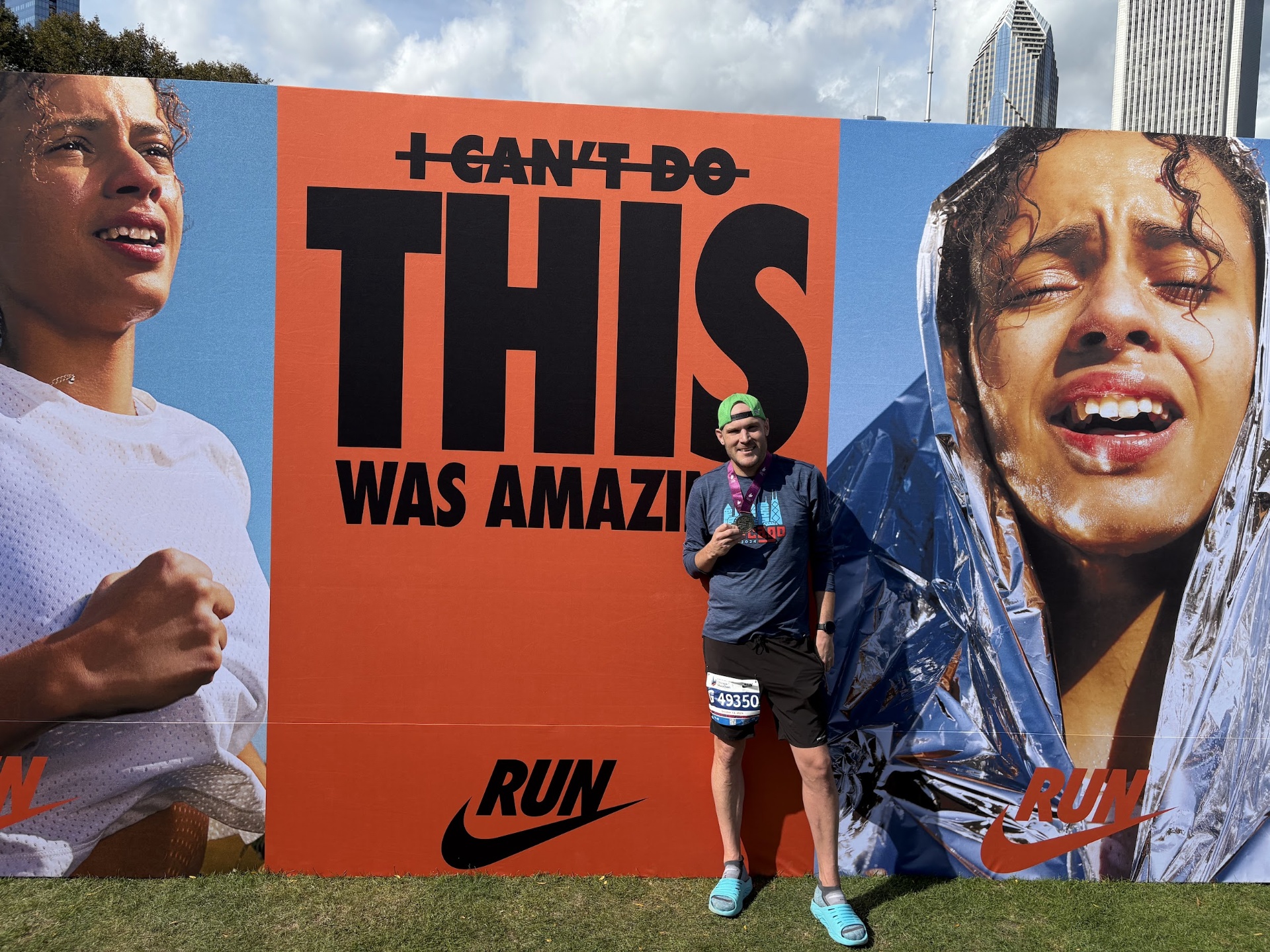 Alex holding his finisher medal in front of the Nike 'I CAN'T DO THIS WAS AMAZING' wall after the Chicago Marathon