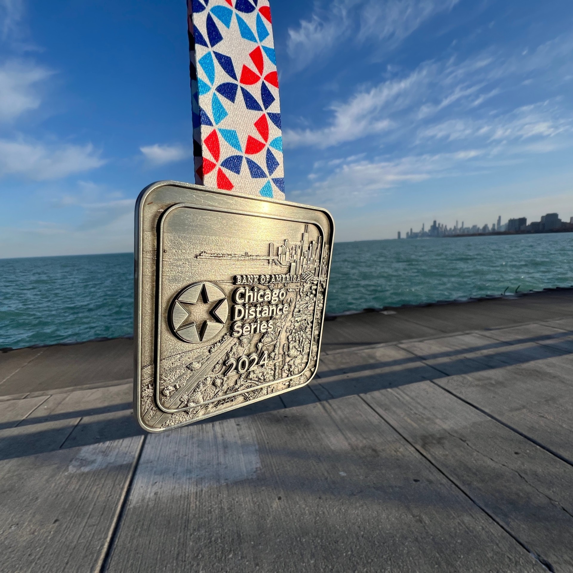 2024 Bank of America Chicago Distance Series finisher medal with Chicago skyline engraving and colorful ribbon