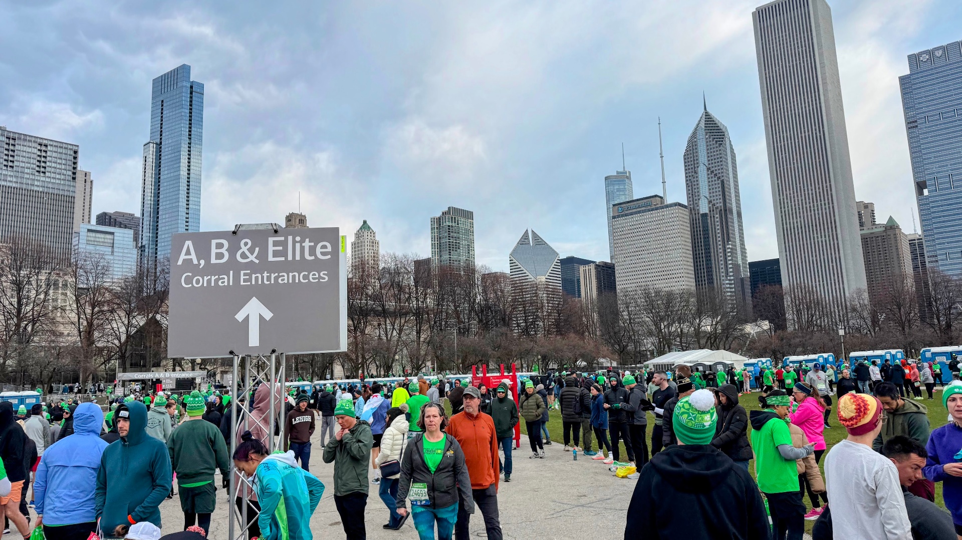 A, B & Elite corral entrance sign on Monroe St. with Chicago skyline behind